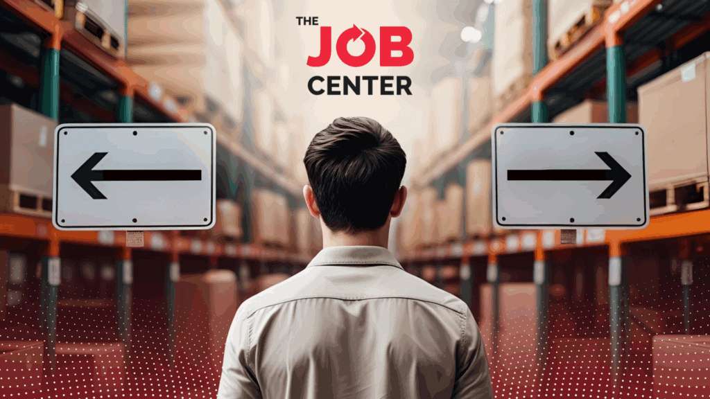 Warehouse worker stands at the edge of a warehouse looking at two signs pointing left and right